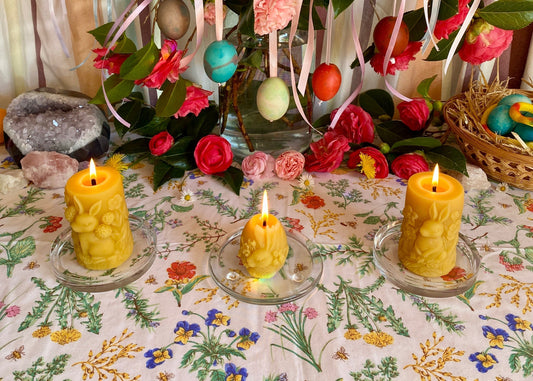 Spring seasonal altar with rabbit beeswax candles, colourful dyed eggs and flowers